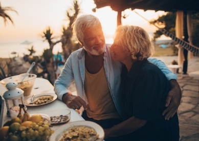 Senior couple having dinner on beach